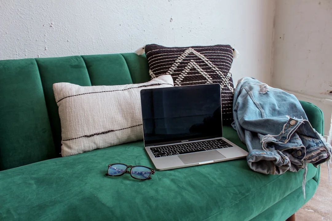 Close-up of hands interacting with a shopping website on a laptop screen indoors.