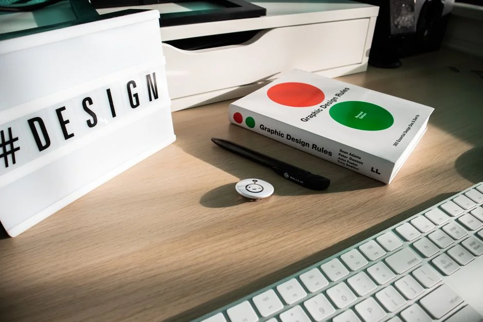Dual monitors on a desk, showcasing web design in a modern office setting.